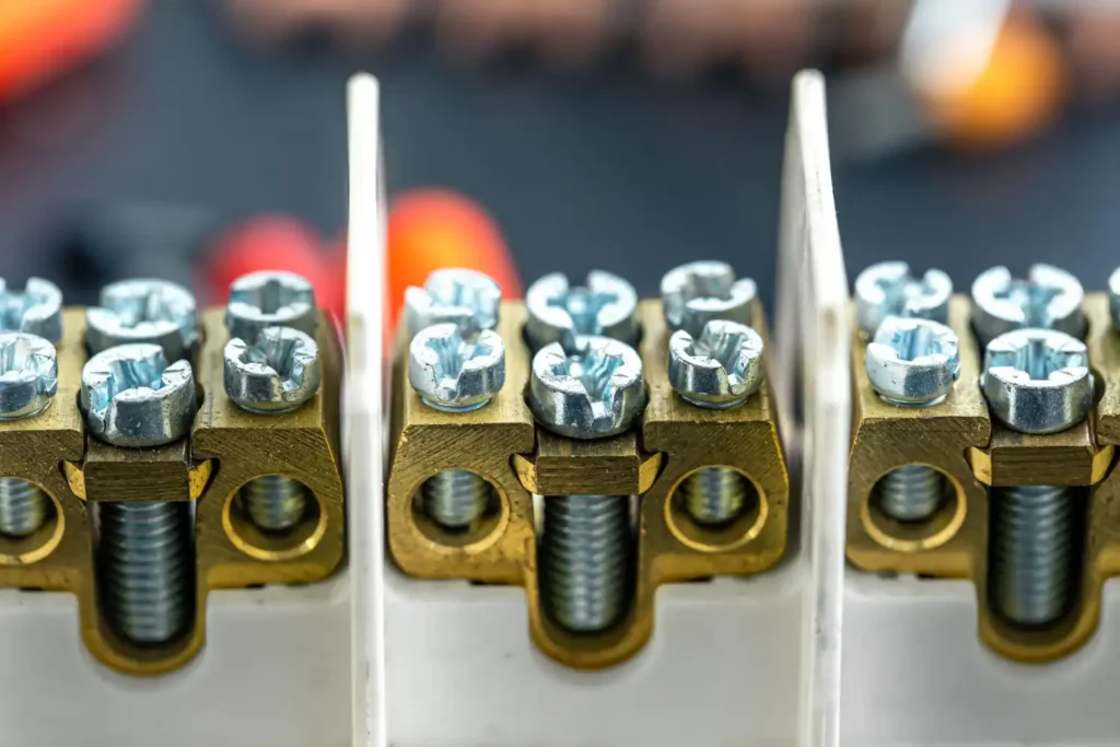 Aplicações do Parafuso Auto Brocante em Obras Industriais, mostrando uma montagem de parafusos auto brocantes fixados em uma placa de ligação metálica utilizada na construção civil e obras industriais.
